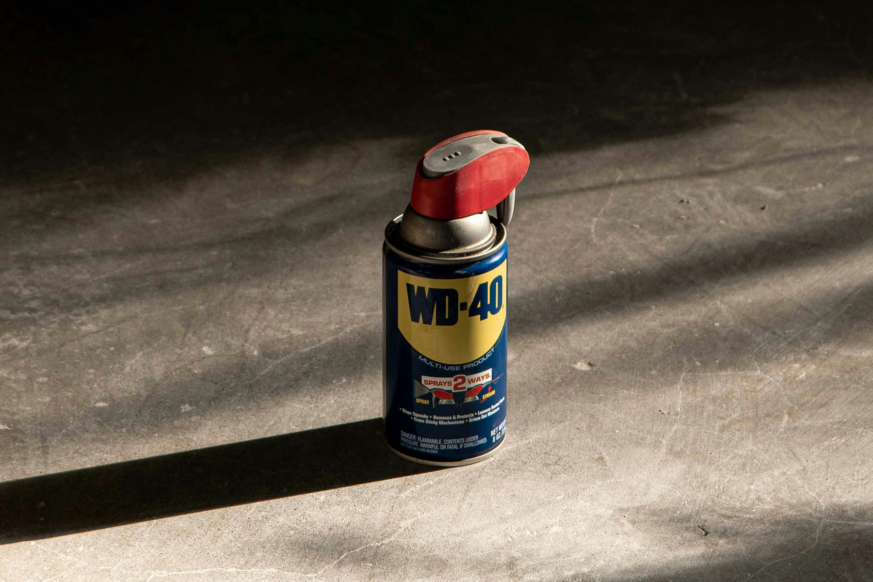 Spraydose mit Schmiermittel auf Werkstattboden